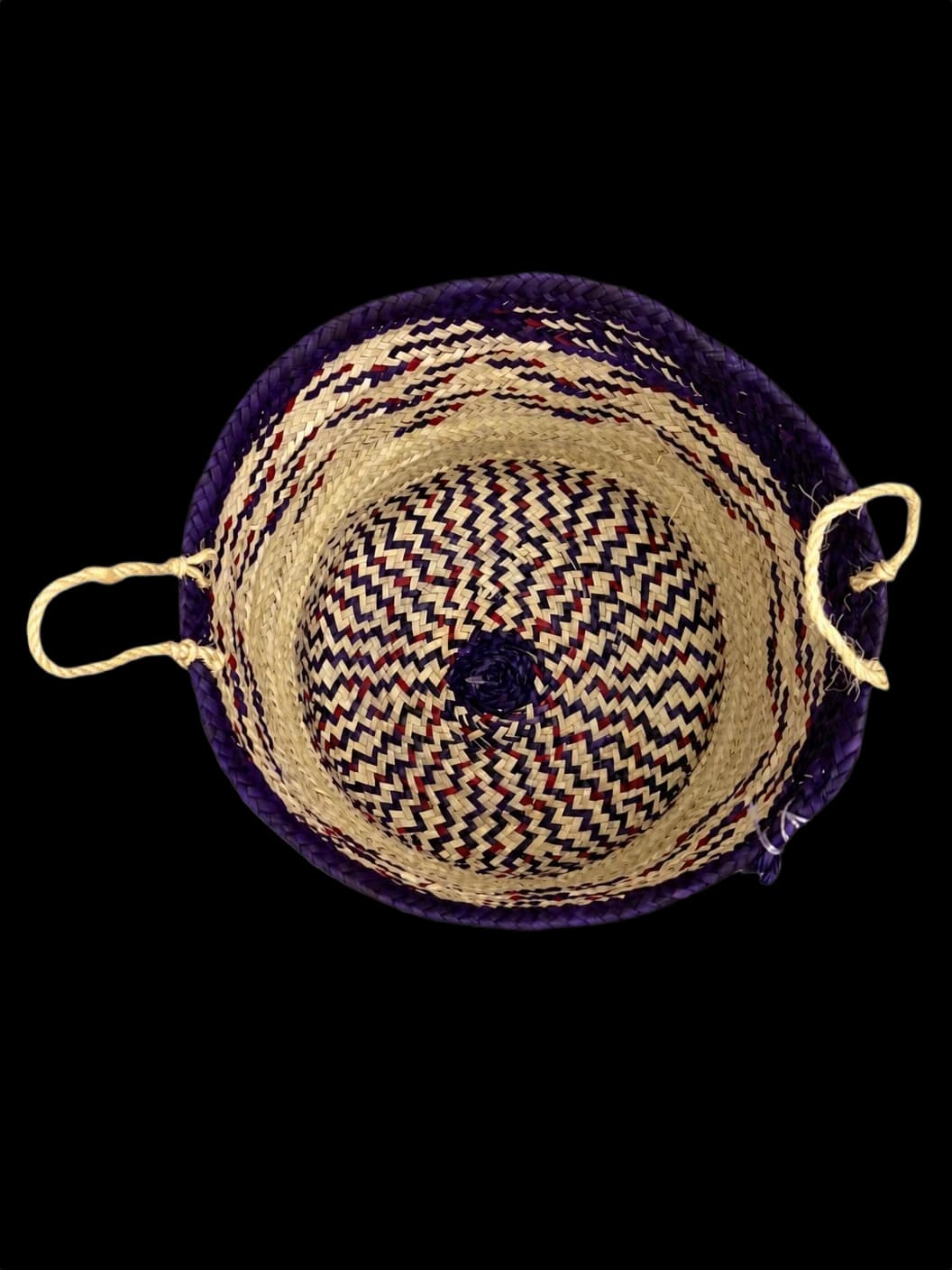 Purple palm-leaf basket with a zigzag pattern and rope handles — top view