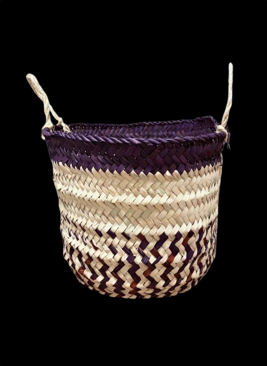 Small handwoven palm-leaf basket with a purple rim