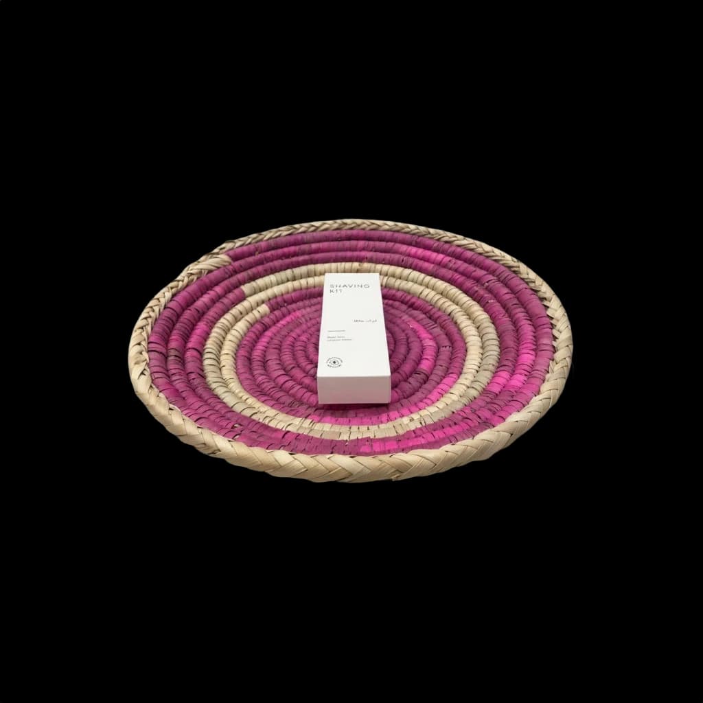 Fuchsia palm-leaf tray presenting a product box